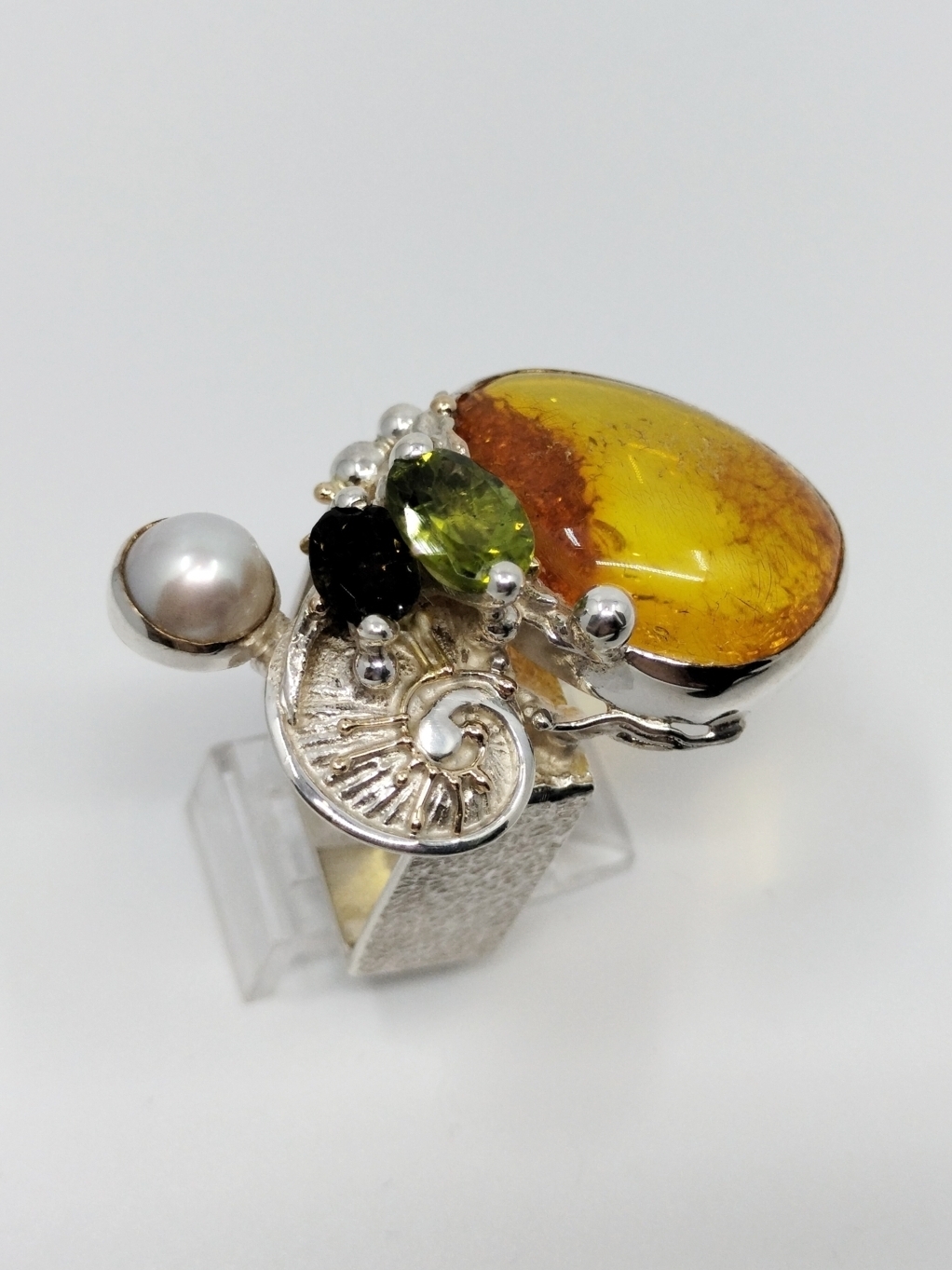 original maker's handcrafted jewellery, gregory pyra piro ring 84942, sterling silver and 14 karat gold, amber, peridot, green tourmaline, pearl, art nouveau inspired fashion jewelry, jewellery with natural pearls and semi precious stones, contemporary jewelry from silver and gold, art jewellery with colour stones, contemporary jewelry with pearls and color stones, jewellery made from silver and gold with natural pearls and natural gemstones, shopping for diamonds and designer jewellery, accessories with color stones and pearls, artisan handcrafted jewellery with natural gemstones and natural pearls, jewelry made first hand, art and craft gallery artisan handcrafted jewellery for sale, jewellery with ocean and seashell theme