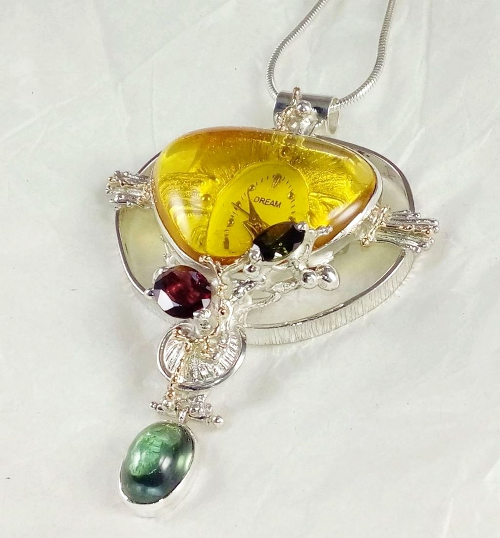color stone jewelry, natural gemstones in silver and gold jewelry, facet cut stone and pearl jewelry, jewellery with natural stones, jewellery with facet cut stones and pearls, jewellery with natural pearls and stones, gregory pyra piro one of a kind pendant with watch #837264, handcrafted jewelry in art and craft galleries, handmade pendants in international jewelry trade shows, handcrafted pendants made by artist from silver and gold, mixed metal jewellery made from gold and silver, jewelry inspired by retro fashion, auction style one of a kind jewellery made by jewellery maker, antique style handcrafted jewellery made by jewellery maker, pendant with amber and green tourmaline, handcrafted pendant with watch, pendant with garnet and green tourmaline