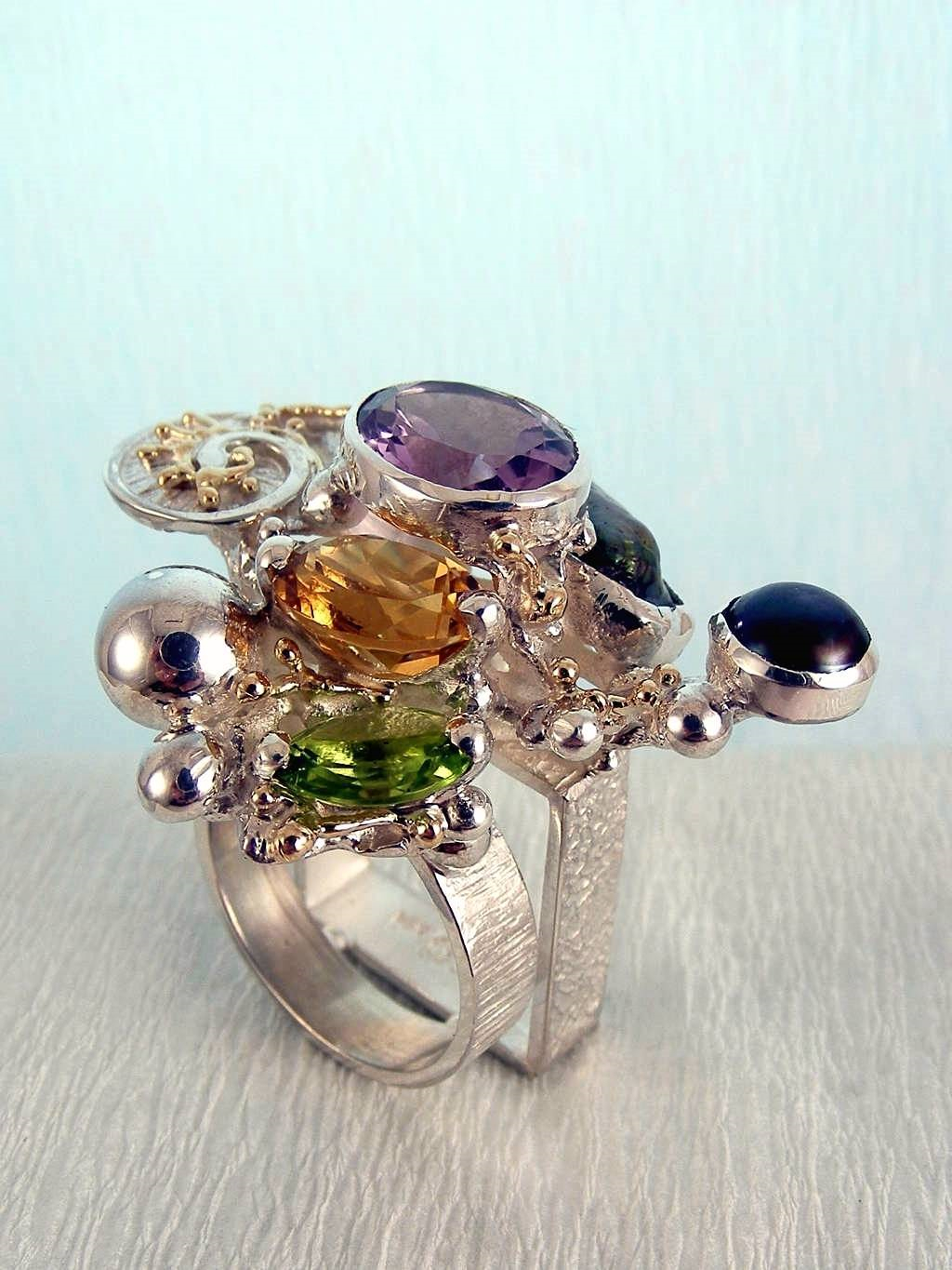 jewelry with semi precious stones, jewelry that has solid 14 karat gold, facet cut gemstones in jewelry, gregory pyra piro cyber ring 1565, mixed metal silver and gold jewelelry, rings in art and craft galleries, cyber rings for women with amethyst and peridot, cyber rings for women with amethyst and citrine, cyber rings for women with citrine and peridot